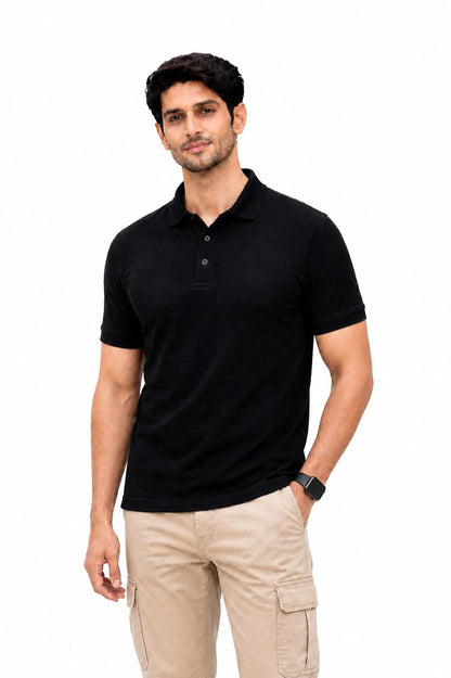 Man wearing a black polo shirt and beige pants on a white background